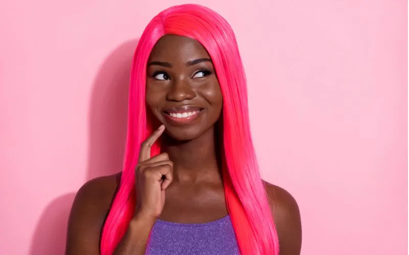 Woman wearing the best human hair wig for african americans in pink