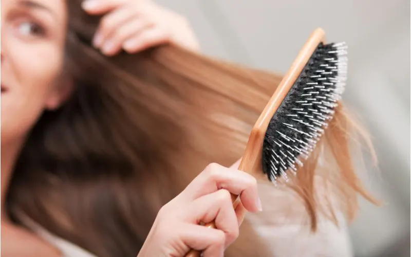 Woman fixing damaged hair by changing her brushing technique