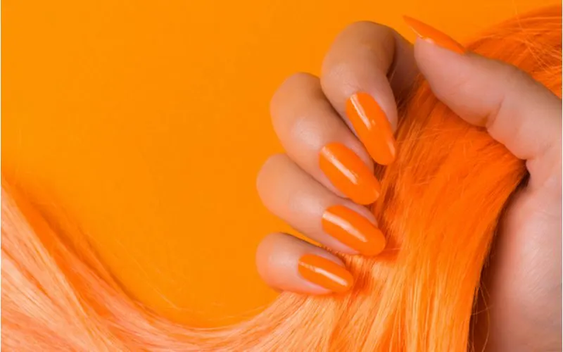 Women about to use blue toner for orange hair with orange nails