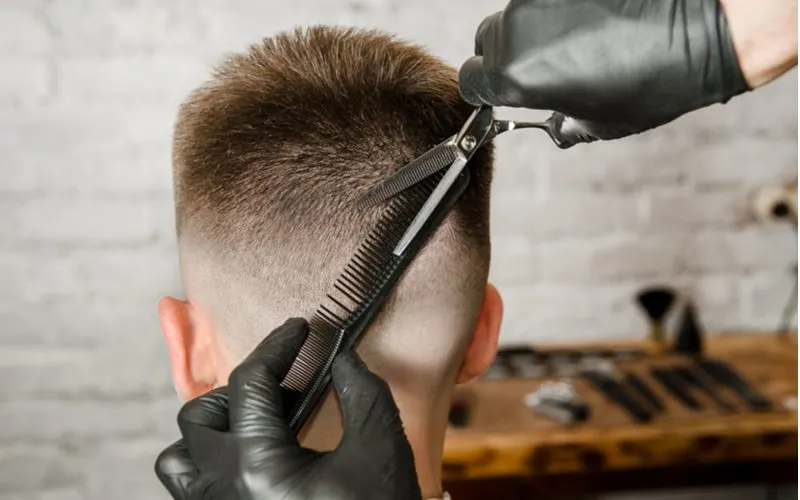 Man doing a fade for a piece titled How to Cut Your Own Hair Men