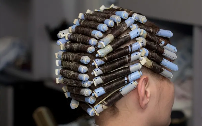 Woman getting a cold (or alkaline) perm on her hair