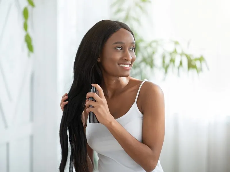 Woman showing us how to moisturize relaxed hair without weighing it down