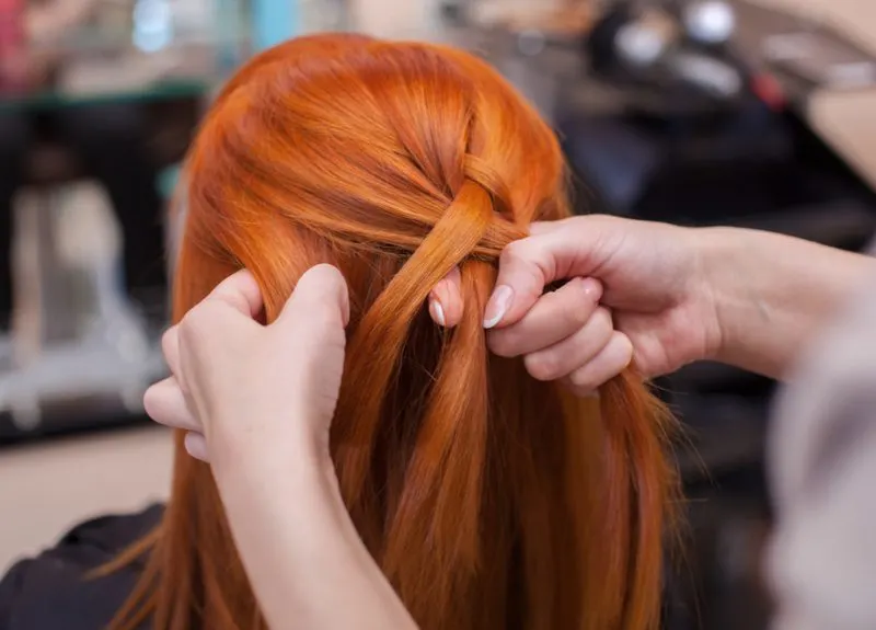 Redhead learning tips for French braiding your own hair
