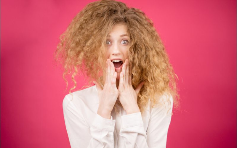 Woman screaming because she has dry frizzy hair after a perm
