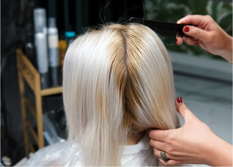 Woman showing us how to fix uneven bleached hair