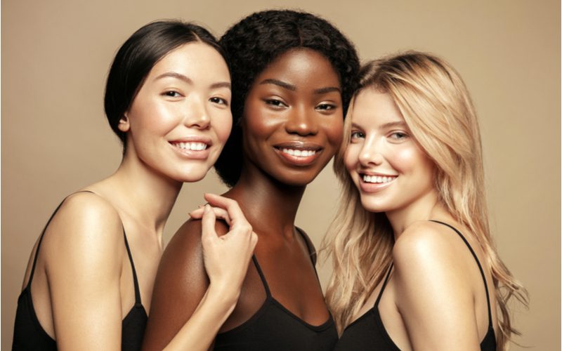 For a featured image for an is my hair thick or thin quiz, several woman with different hair types huddle together