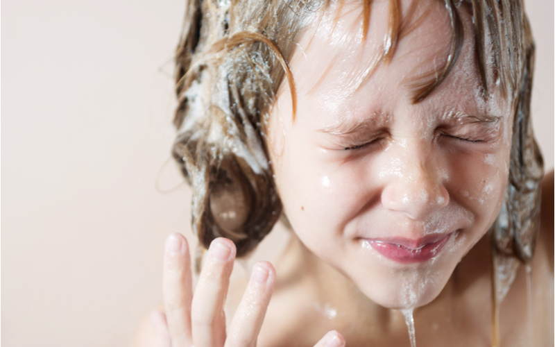 Girl using a tear free shampoo for a piece explaining what it is