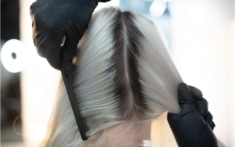 Woman who needs root touch ups on her silver hair