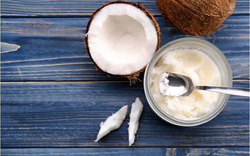 Coconut oil on a table to fix a deficiency found in our does my hair need protein quiz