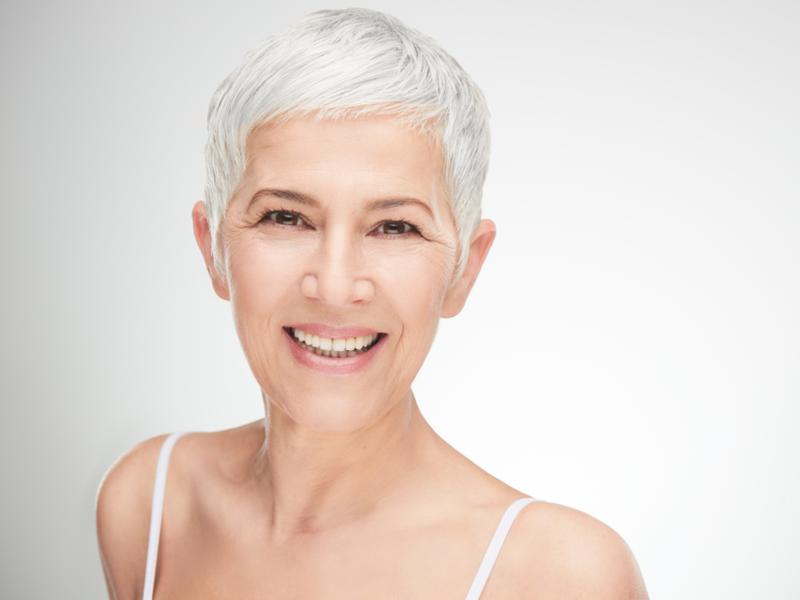 Woman transitioning from colored to grown out gray hair