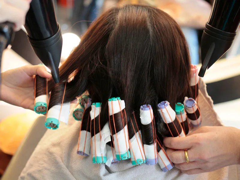 Woman who needs the best shampoo for permed hair getting a perm