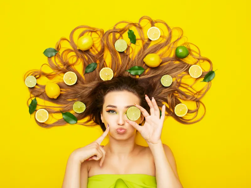 Featured image to help answer What Is Citric Acid in Shampoo featuring a woman with lemons in her hair