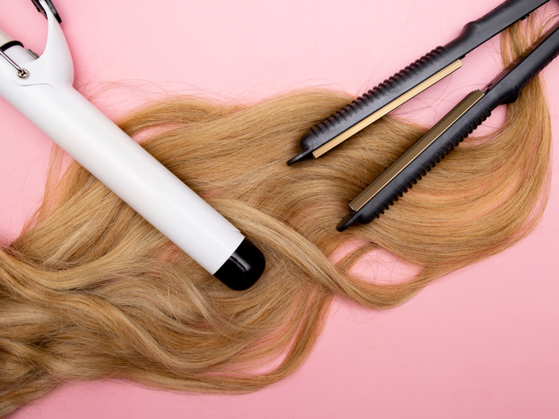 Image of a bunch of hair on a pink table for a piece on why your hair is falling out