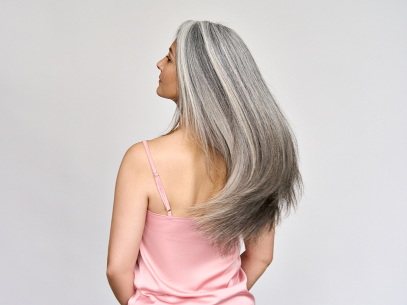 Woman learning how to grow out gray hair that is colored