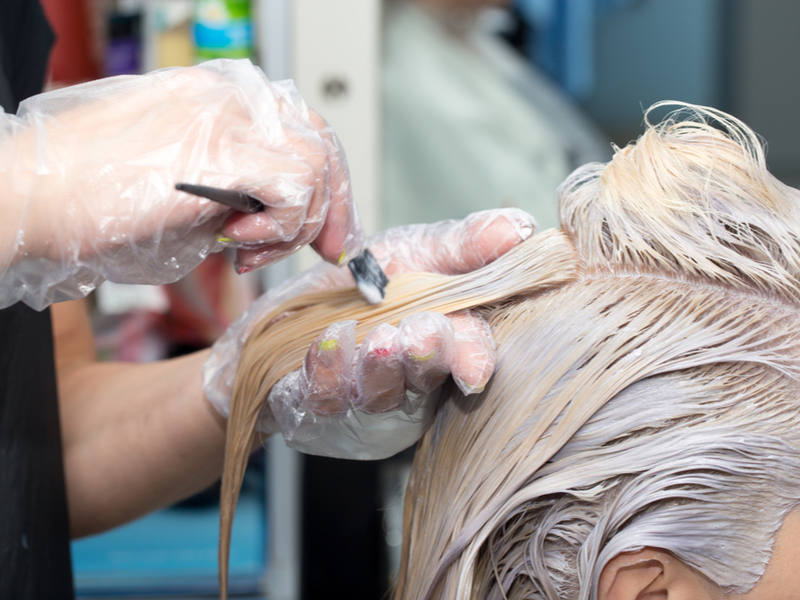 Woman in one of the last stages of hair bleaching in the salon