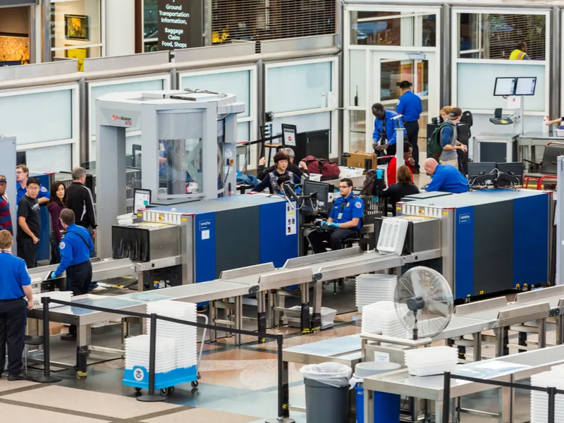 TSA security line in Denver's airport to illustrate if you can bring hair cutting scissors on a plane
