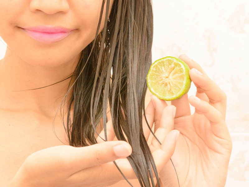 Woman using lemon in hair overnight to lighten it