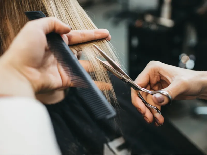 Woman texturizing hair in a salon