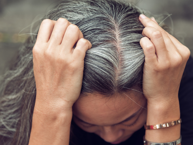 Woman wondering why her grey hair won't dye