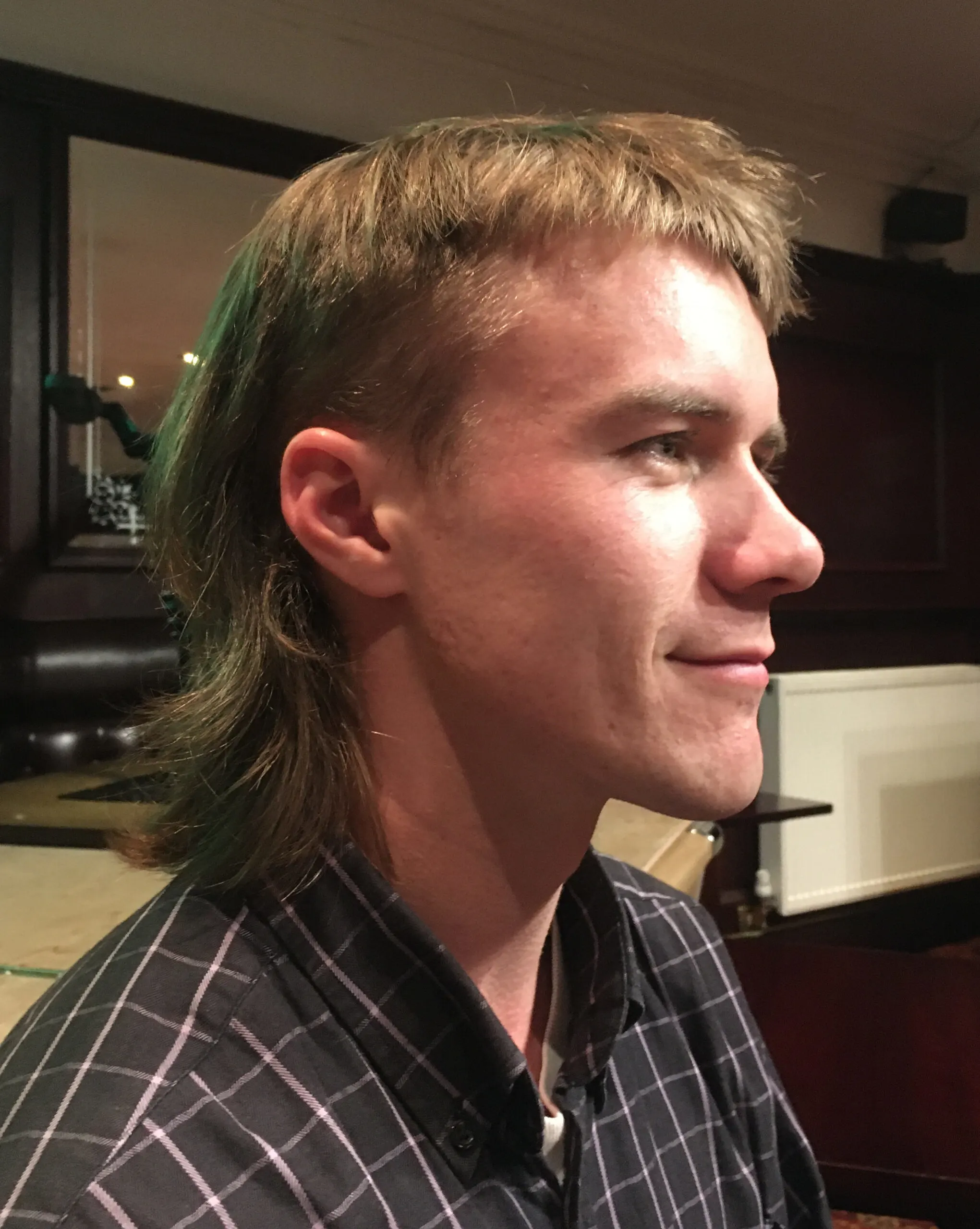 Modern Mullet on a guy in a black checkered shirt