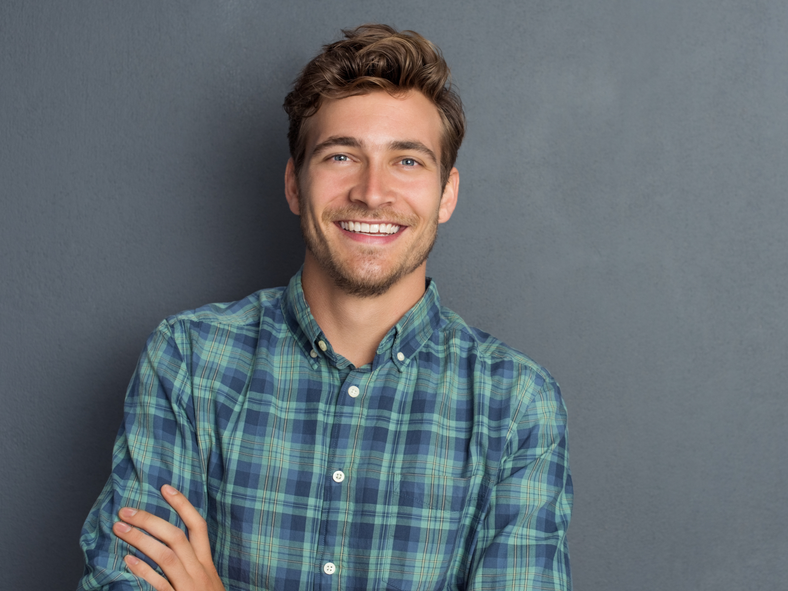 Medium Chocolate Brown hair color idea for men on a guy in a plaid shirt