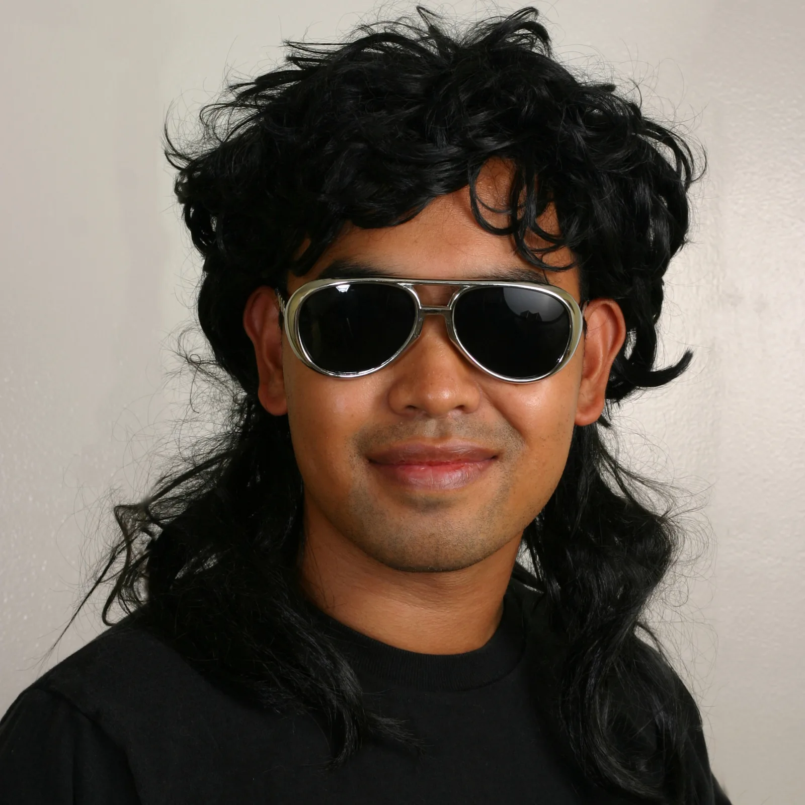 80s type of mullet on an Asian guy in black sunglasses in a school-type photo