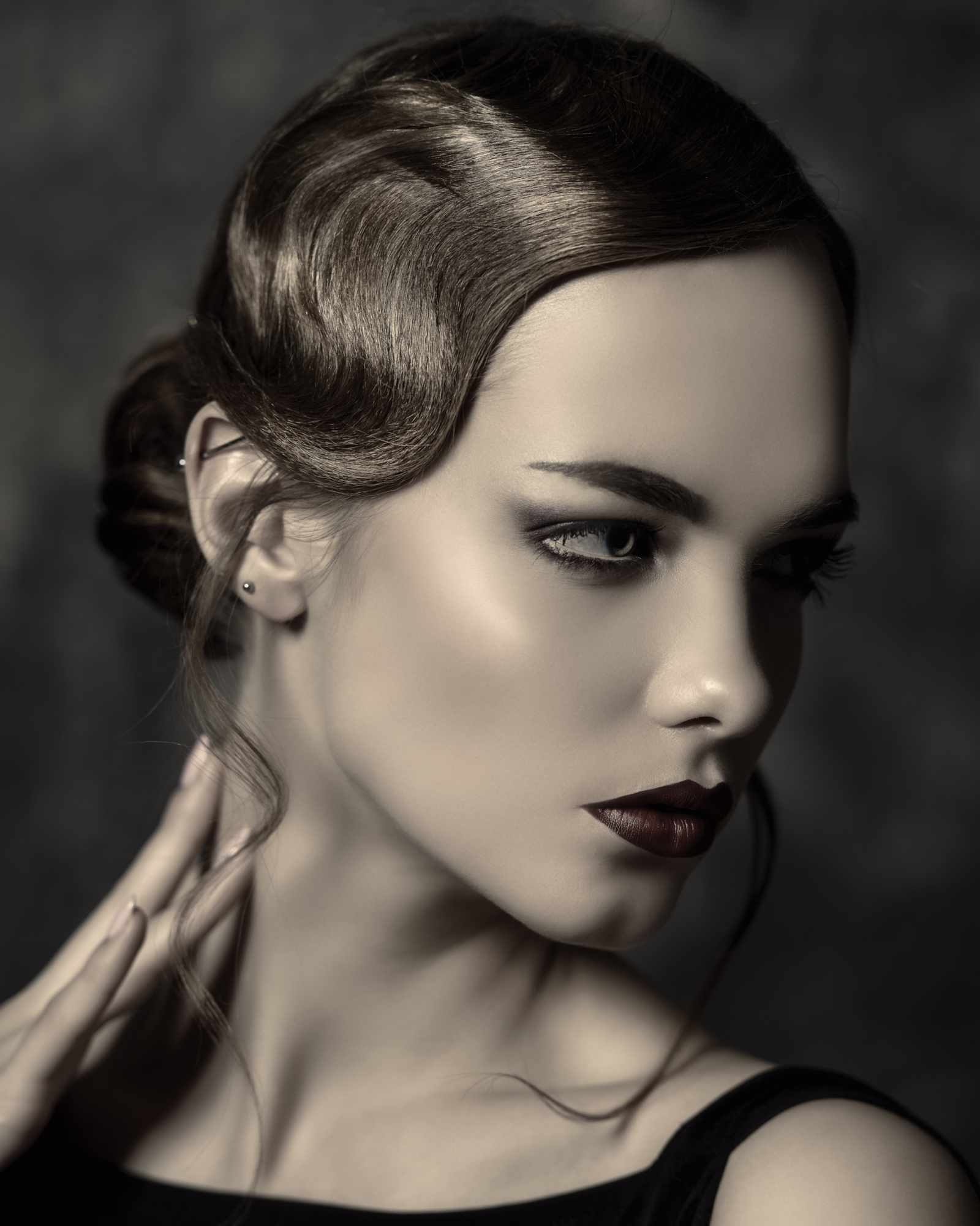 Classic Sleek Finger Waves With Low Bun on a woman in a black and white image