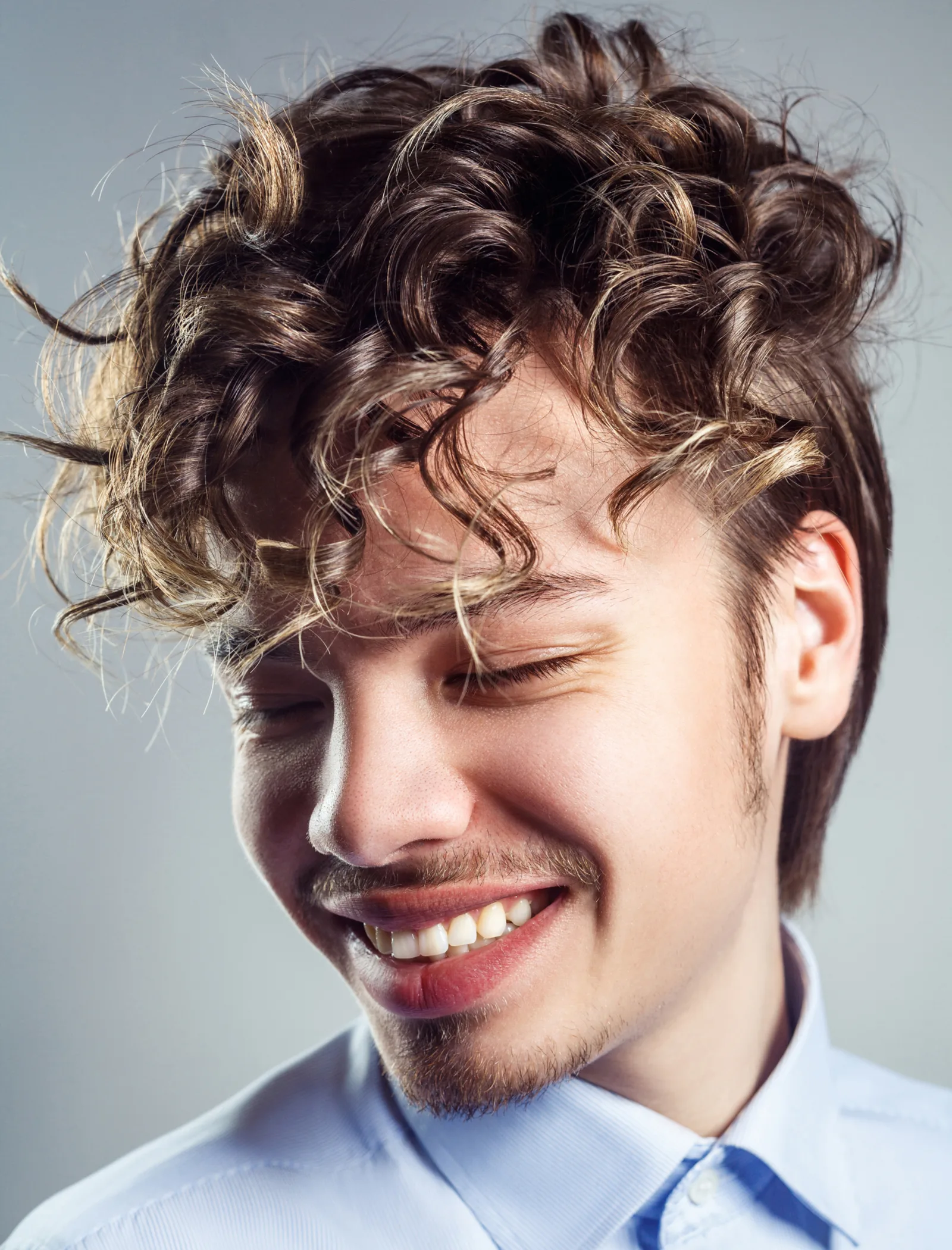 Face-Framing Blonde Highlights on a Curly Dark Haired Male