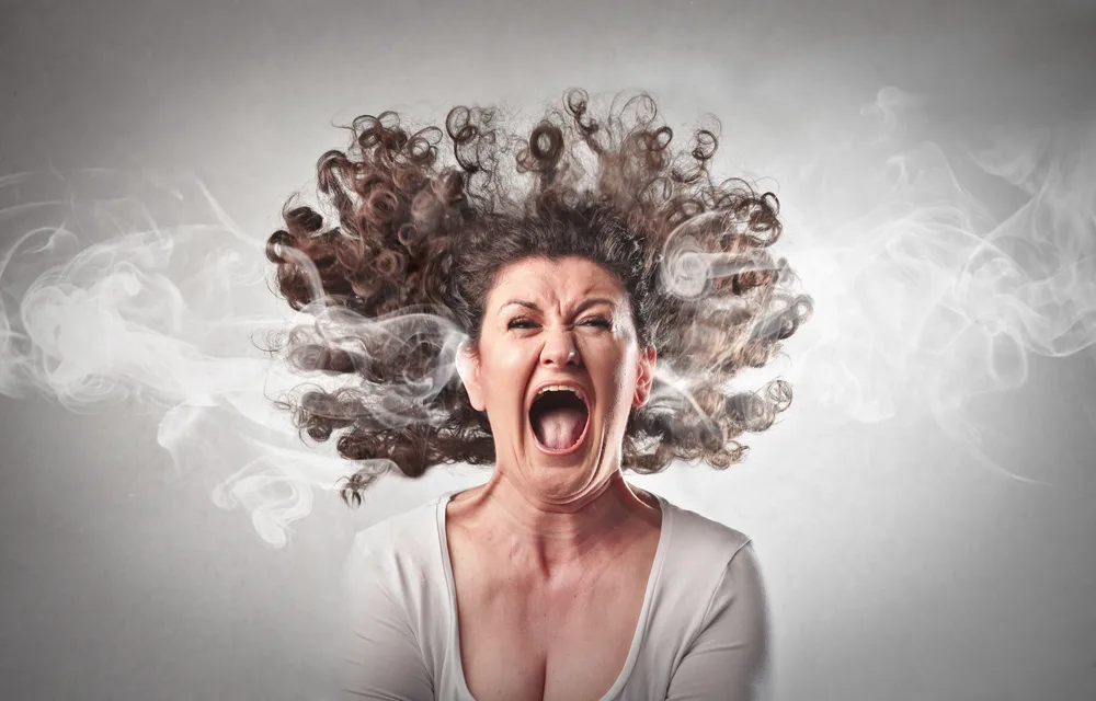Woman screaming in panic because she can't get rid of burnt smells in her hair