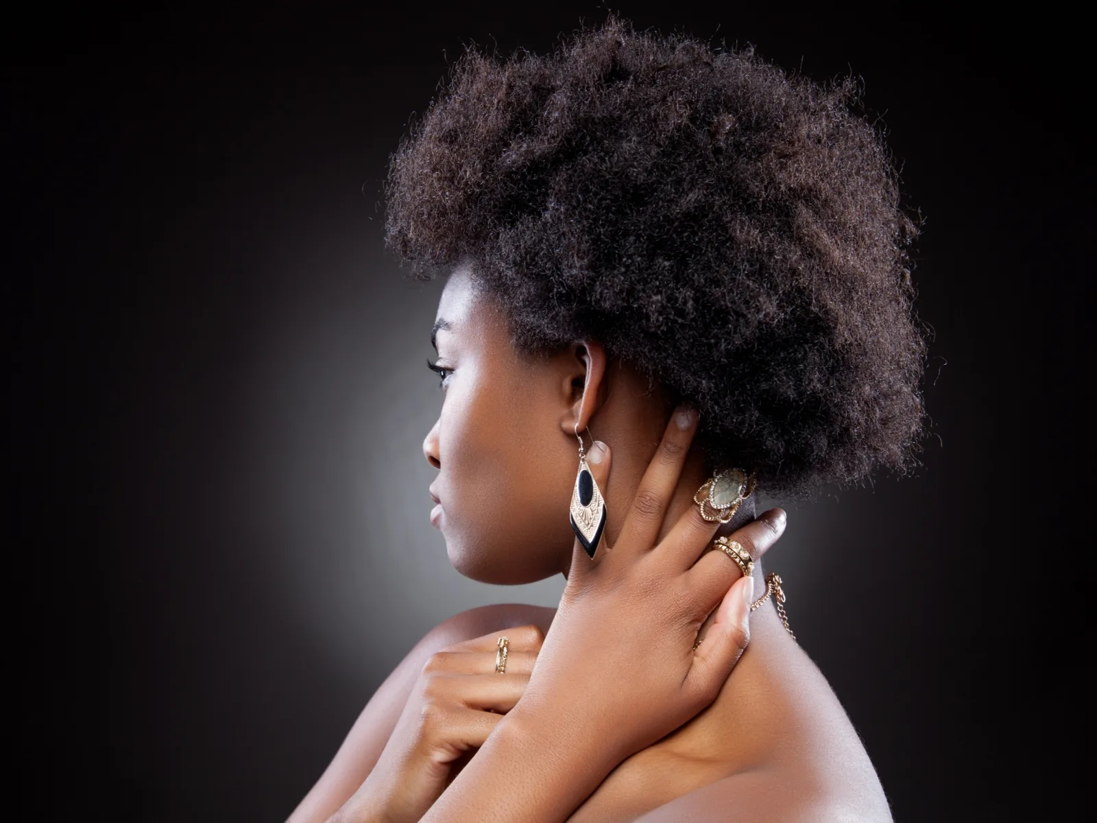 As an idea for short haircuts for black women, a young women wears the Tapered 4C Afro style