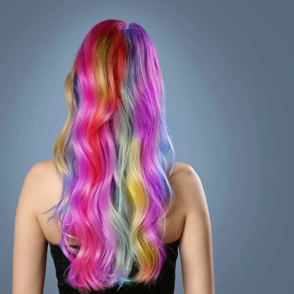 Woman with rainbow highlights pictured as an idea of the best hair colors for neutral skin tones