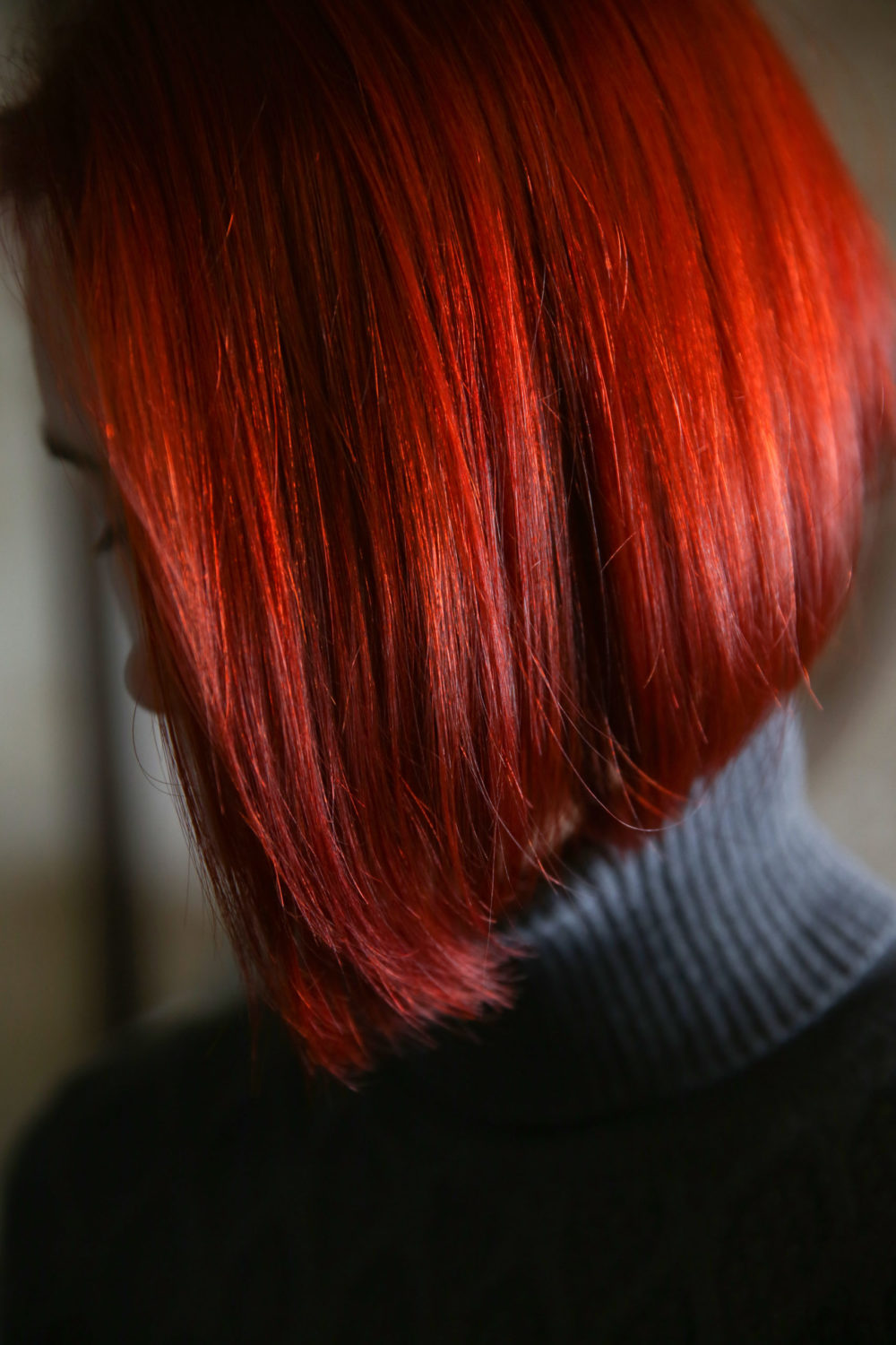 True Red hair color, one of the best for pale skin, on a woman in a turtleneck