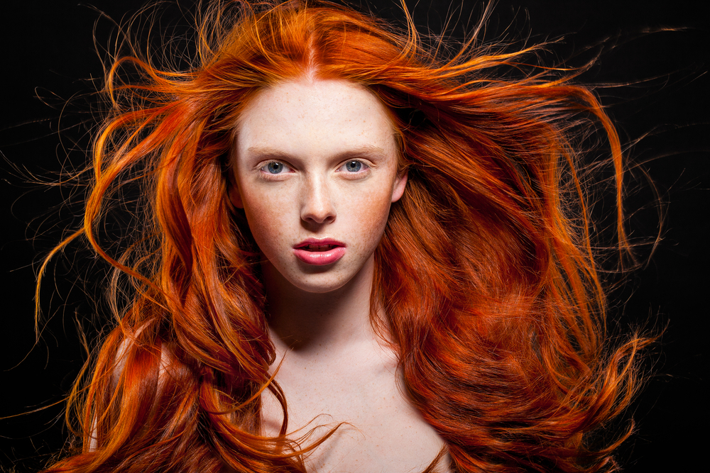 Bright Orange Copper ginger hair color on a woman with freckles