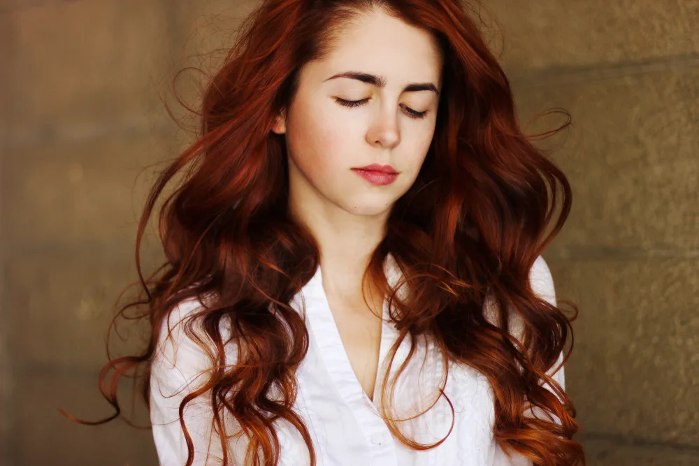 Deep Violet Red hair on a woman with pale skin in a white shirt