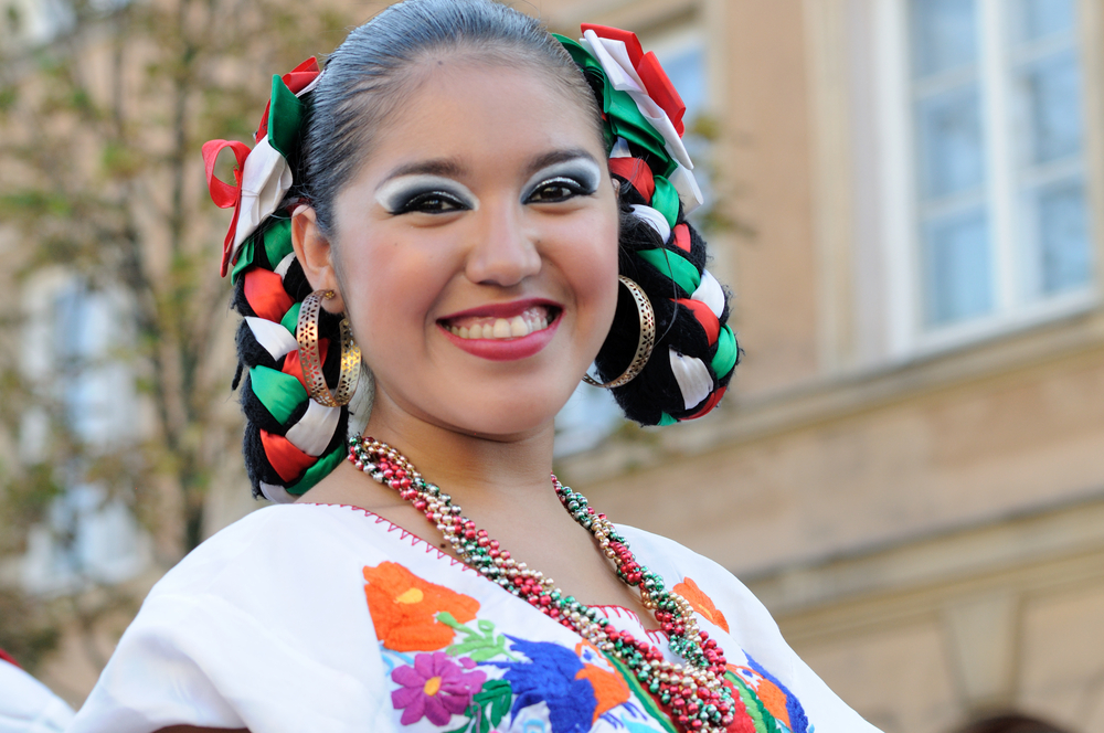 Woman with Looped Ribbon Braids smiles for a post on Mexican Braids Ideas