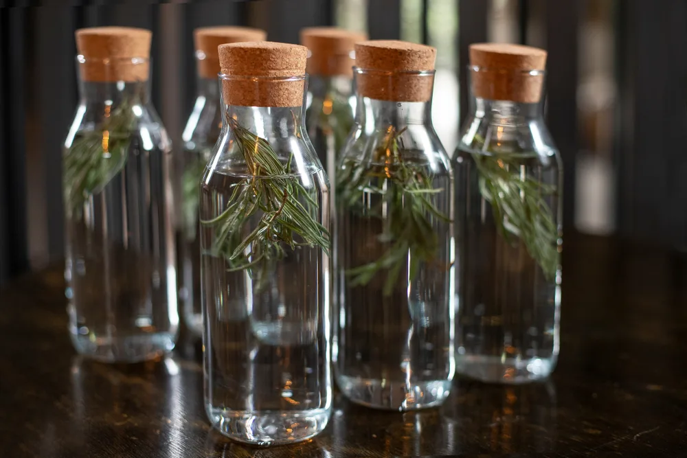 Bottles of rosemary water that will be used on someone's hair