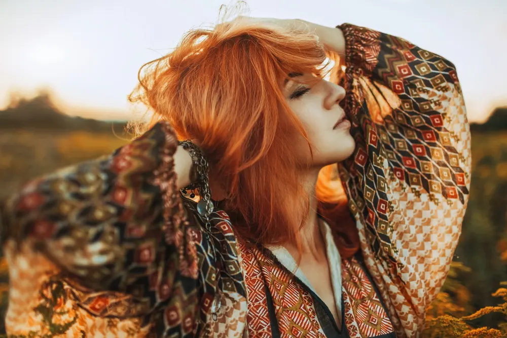 Dimensional Medium Copper Ginger Hair Color on a boho-style woman