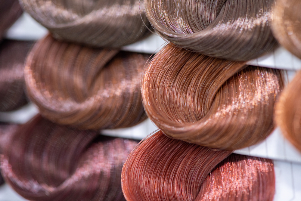 Various shades of dark brown hair color on samples on a shelf