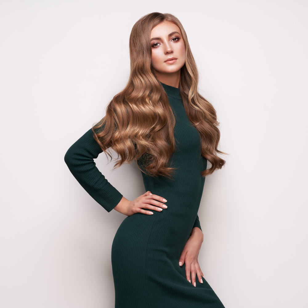 Tawny Autumn Blonde fall hair color on a woman in a black dress