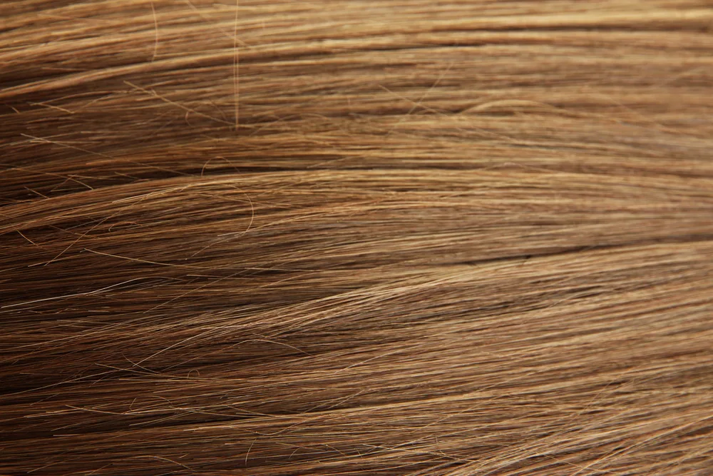 Shiny chestnut brown hair close-up background