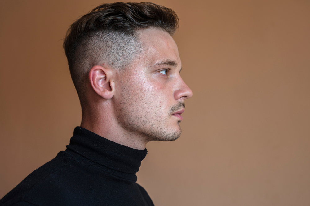Image for a piece on How to Grow Out a Short Undercut featuring a guy in a black turtleneck