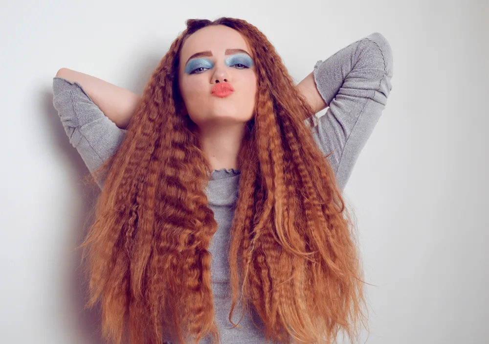 Crimped Strands on a woman holding her arms above her head