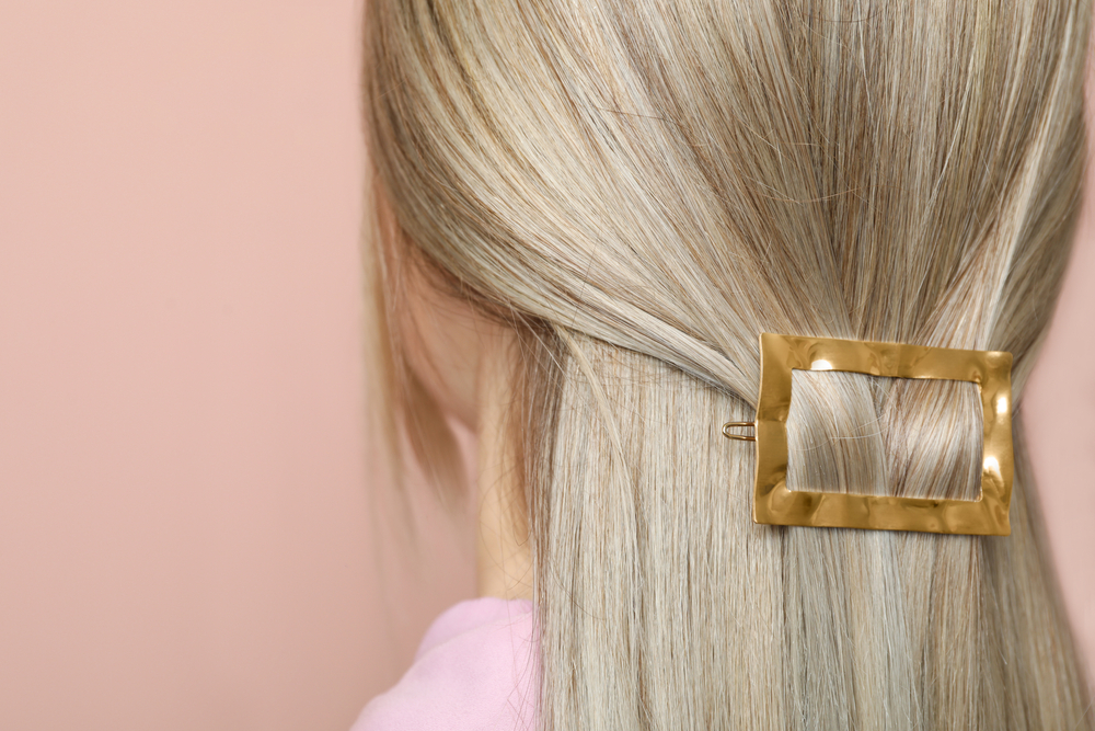 Blonde woman with the best hair clip for thin hair pictured in a close up from behind