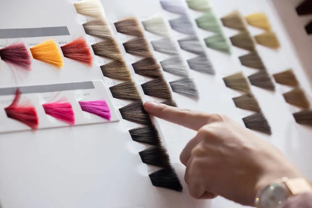 Photo of a woman choosing the best hair dye colors without needing bleach