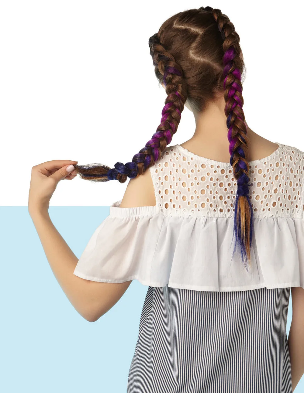 Zigzag Parts, one of the trending y2k hairstyles, on a woman in a blouse and striped skirt