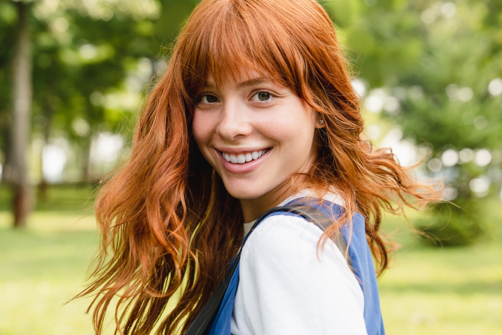 Ocher Orange With Bangs and Layers orange hair color idea