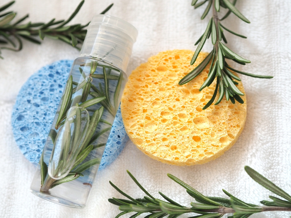 Image of rosemary in water next to a sponge for a piece on rosemary water for hair