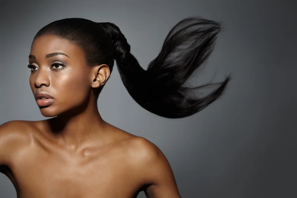 Sleek Ponytail pictured as one of the best hairstyles for black women over 50