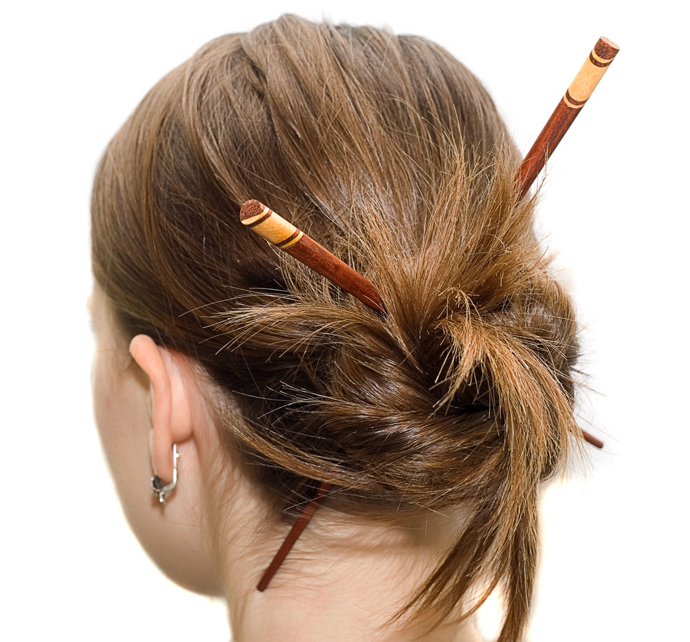 Y2K Hair Sticks on a slightly asian-looking woman look away from the reader