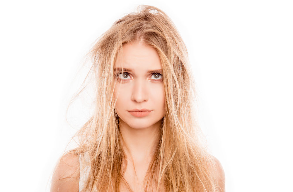 Image of a woman with hair damage because she didn't use the best shampoo for blonde hair on a white background